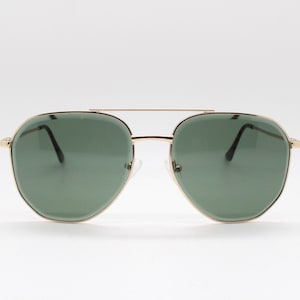 May include: Gold-framed aviator sunglasses with green lenses.