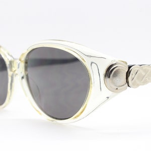 90s vintage cat eye sunglasses. Oval transparent curved cat eye with big crest and contrasting black arms and lenses. Rave de luxe. NOS