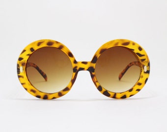 60s design sunglasses. Round oversized tortoise frame with brown lenses. Womens. 70s.