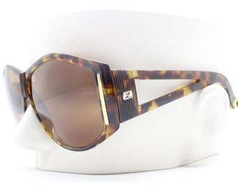 Courreges 70s vintage sunglasses. Womens charismatic abstract pentagon tortoise frame with cut out arms. 60s