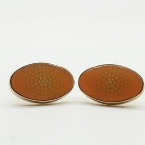 Thomas PInk vintage oval cuff links made in England. Peach enamel with psychedelic dotted sunburst pattern. NOS