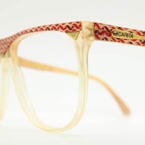 Carita 80s vintage eye glasses made in Italy. Flat top crystal, red and gold patterned optical frames. Prescription eyeglasses. Unused NOS