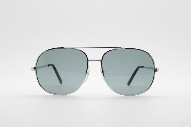 May include: Silver aviator sunglasses with gray lenses.