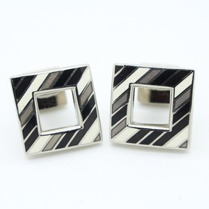 Vintage striped square cuff links made in England. Solid metal with cut out centre in grey and white enamel with matching back. NOS