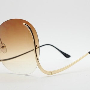 Y2K vintage big round oversized sunglasses. Women&#39;s upside down 70s design with  . dramatic upswept arms and sultry graduating lenses. NOS