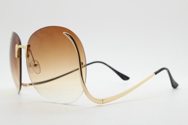 Y2K vintage big round oversized sunglasses. Women's upside down 70s design with  . dramatic upswept arms and sultry graduating lenses. NOS
