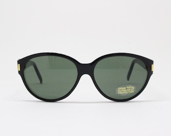 May include: Black oval sunglasses with green lenses and gold accents. The sunglasses have a label that reads "UV400 Total Ultraviolet Protection."