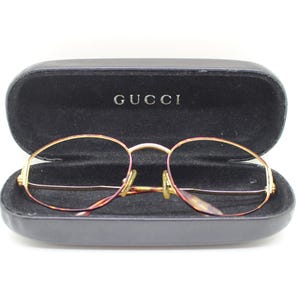 Gucci vintage 90s oval glasses made in Italy. Tortoise and gold optical frames with stirrup temple. Prescription eyeglasses. RX Spectacles