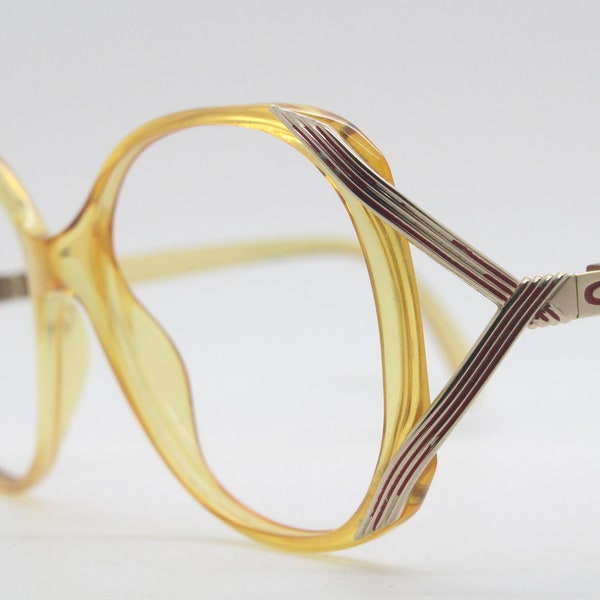 Christian Dior 70s vintage eyeglasses made from Optyl. Transparent yellow large optical frame with unmistakeable temple design. Prescription