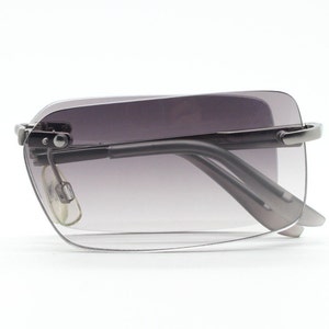 90s vintage folding sunglasses. Minimalistic frameless graduated rectangular lenses on grey metal arms. Foldable. 2000's. Y2K