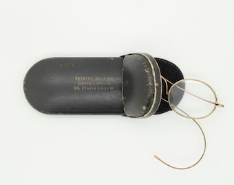 Victorian vintage antique oval glasses. 1800s metal optical wire frame with coiled cable arms. Prescription eyeglasses. Spectacles with case