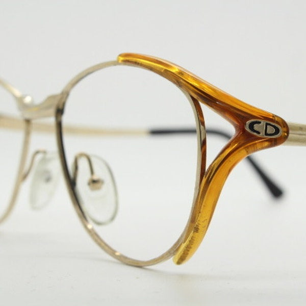 Christian Dior 80s vintage eyeglasses made in Austria. Transparent brown and gold optical frame with characteristic temple fork design. RX