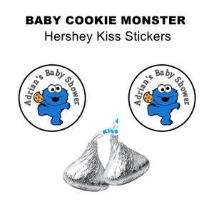 May include: Round blue and white stickers featuring Cookie Monster with the text "Adrian's Baby Shower". The stickers are designed to be placed on Hershey's Kisses.