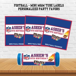 May include: Three blue and red labels with the text "Asher's NFL 8th Birthday m&m's Minis" and a football graphic. The labels are for mini M&M's tubes. A blue and red tube with the same text and graphic is shown in the center of the image.