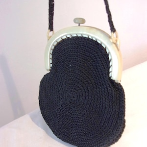 Charming 1920s black knitted pouch bag on celluloid frame