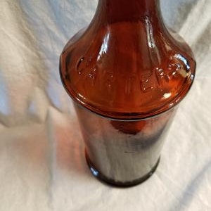 May include: A brown glass bottle with a wide mouth and a label that reads "Carter's Ink".
