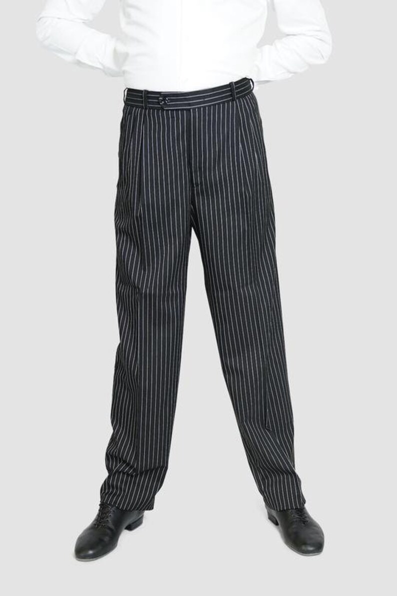 May include: Black and white striped pants with a slim fit. The pants have a classic style and are made of a smooth fabric.