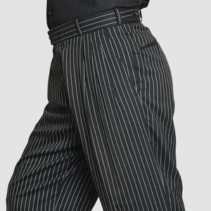 May include: Black and white striped pants with pleats. The pants have a slim fit and a high waist.
