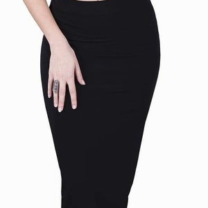 May include: A black pencil skirt with a fitted silhouette. The skirt is made of a smooth, stretchy fabric.