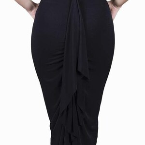 May include: A black skirt with a long, flowing ruffle down the back.