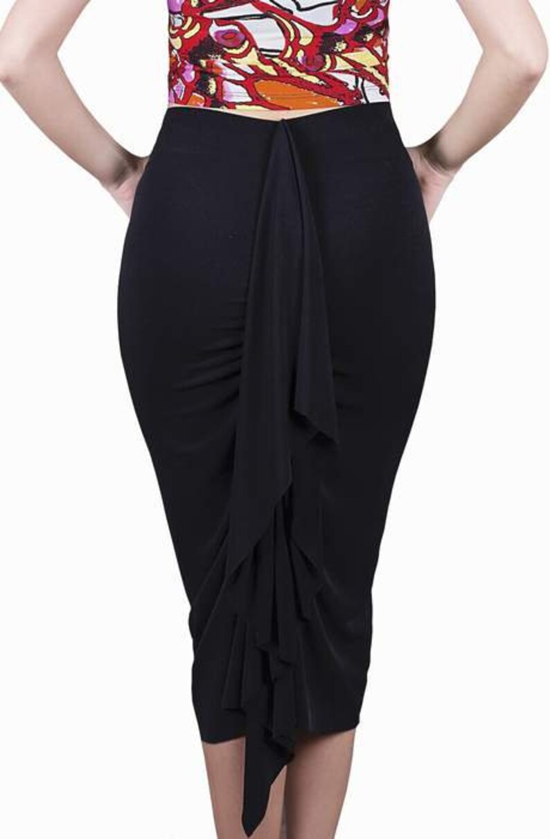 May include: A black skirt with a long, flowing ruffle down the back.