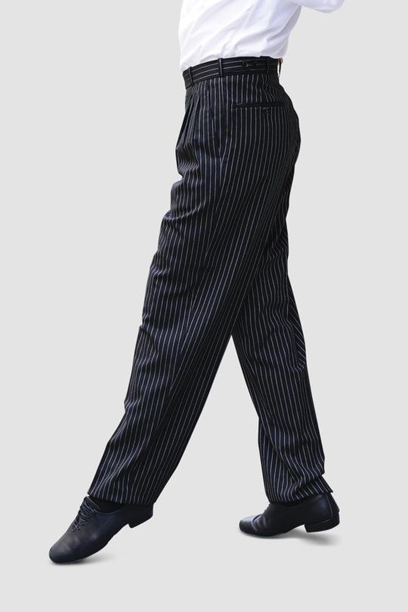 May include: Black and white striped pants with a wide leg and a belt.