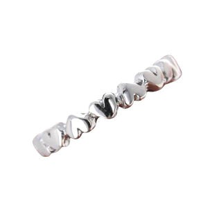 May include: A silver ring with a band of small, connected heart shapes.