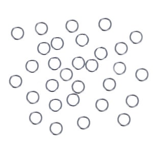 May include: A scattering of silver jump rings, a type of jewelry finding, on a white background.