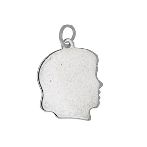 May include: A silver-toned metal charm shaped like the silhouette of a human head in profile. The charm features a smooth, flat surface and includes a small circular jump ring attached to the top for hanging on a chain or bracelet.