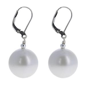 May include: A pair of silver dangle earrings with large white pearl-like spheres.