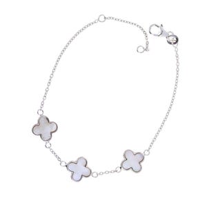 May include: A silver chain bracelet with three white clover-shaped charms.