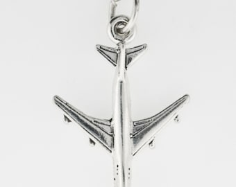 May include: A silver-colored airplane charm with detailed wings and tail. The charm has a loop at the top for attaching to a necklace or bracelet. The airplane charm is a travel-themed accessory.
