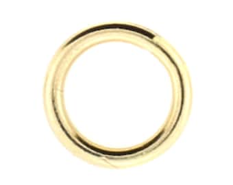 May include: A gold-colored metal jump ring.