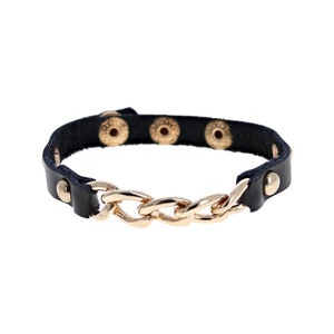May include: A black leather bracelet with gold-toned chain links and decorative studs.