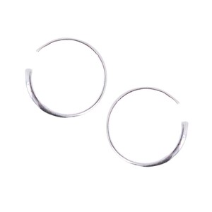May include: A pair of silver hoop earrings. The hoops are simple and circular in shape.