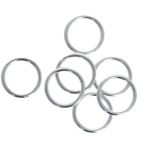 May include: A set of eight silver jump rings, perfect for jewelry making or crafting projects.