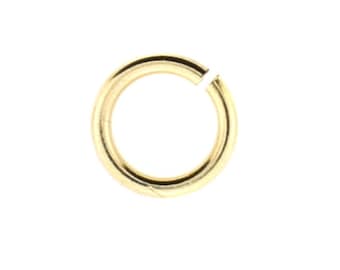 May include: A single gold-colored jump ring, open and ready for use. The ring is circular with a small gap, allowing it to be attached to other jewelry components. The metal has a shiny, reflective surface.