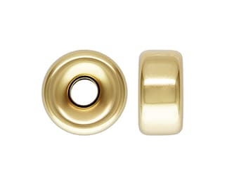 Könnte beinhalten: Zwei goldfarbene Metall-Perlenabstandshalter. Die Perle links ist von oben, die Perle rechts von der Seite zu sehen.