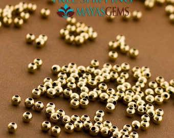 May include: A large quantity of gold-colored round beads, scattered on a brown surface.  FREE SHIPPING MAYAS GEMS