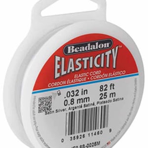 May include: A spool of white Beadalon Elasticity elastic cord, 82 feet (25 metres) long, with a diameter of 0.032 inches (0.8 mm). The label reads "Satin Silver, Argenté Satiné, Plateado Satina".
