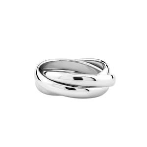 May include: A silver ring featuring three intertwined bands. The bands have a smooth, rounded design, forming a continuous loop. The ring's polished surface reflects light, and it is set against a plain white background, emphasizing its modern aesthetic.