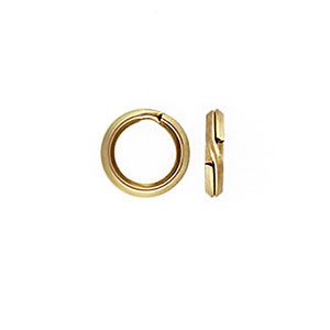 May include: Gold-toned metal jump rings, a common jewelry making supply. The rings are open and ready to be connected to other jewelry components.