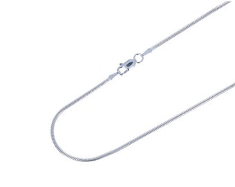 May include: A silver-colored snake chain necklace with a lobster clasp. The chain has a smooth, flexible texture and is displayed against a white background. The necklace is a simple, elegant piece of jewelry.