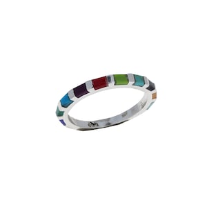 May include: A silver band ring with a colorful inlay of turquoise, red, green, purple, and blue stones.