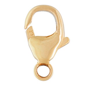 May include: Gold-tone lobster clasp with a spring ring closure. The clasp is marked "GF" for gold filled.