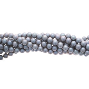 May include: A strand of grey pearl beads. The pearls are round and smooth, and they are strung on a clear thread.