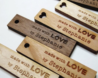 May include: Five wooden tags with heart cutouts and the text "made with LOVE by Stephanie" in a brown font.