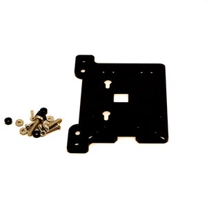 May include: Black metal plate with four screw holes and two keyhole slots. The plate is accompanied by a pile of screws and nuts.