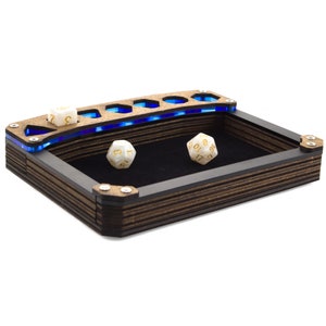 May include: A wooden dice rolling tray with a blue LED light strip. The tray has a black felt lining and a compartment for dice. Two white dice with gold numbers are on the felt.