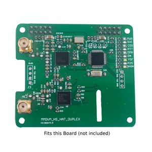 May include: A green circuit board with a variety of components, including a chip, resistors, and capacitors. The board is labeled "MMDVM_HS_HAT_DUPLEX (C) 2018 V1.0".